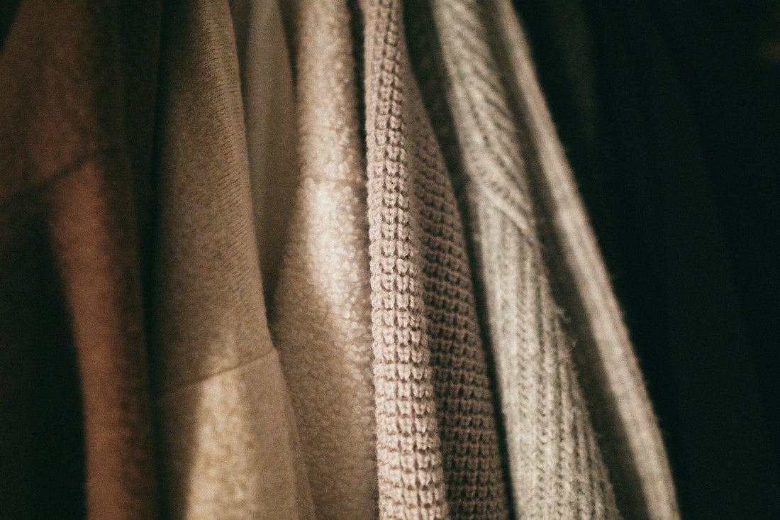 Hanging Cashmere Sweaters. Photo by Haley Truong on Unsplash