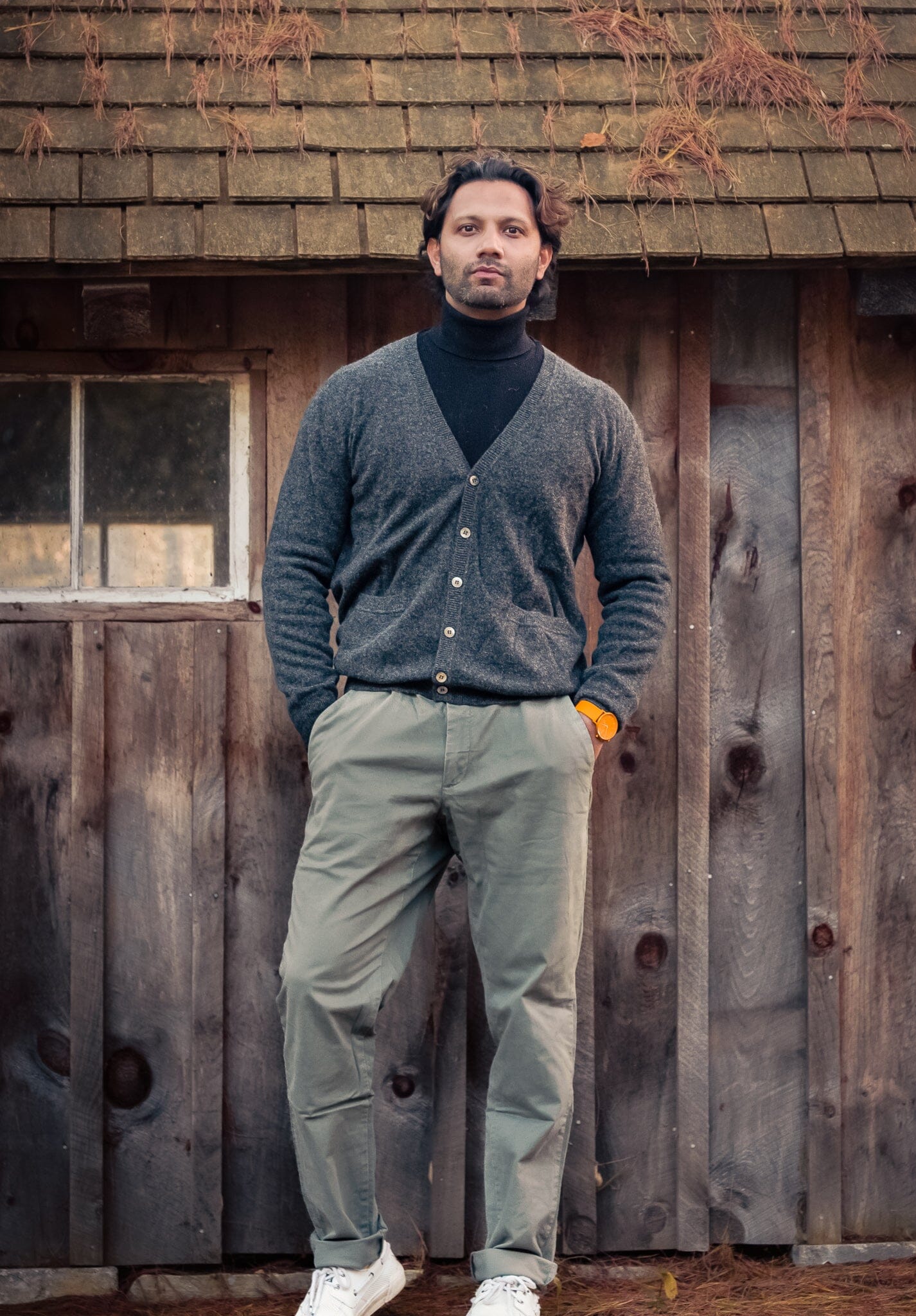 Model posing in the gray cashmere men's v-neck cardigan